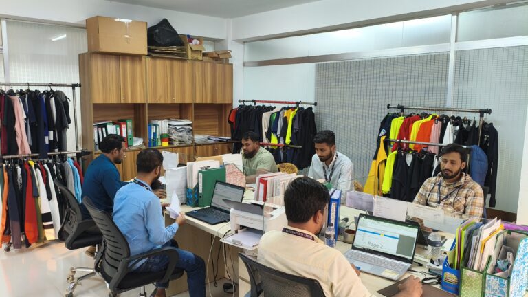 Apparel sourcing staff in an office with sample racks – M&A Sourcing Ltd.